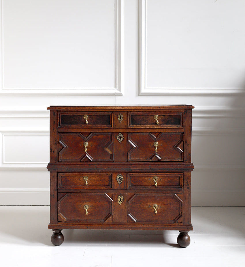 Wooden dresser with multiple drawers on a white background