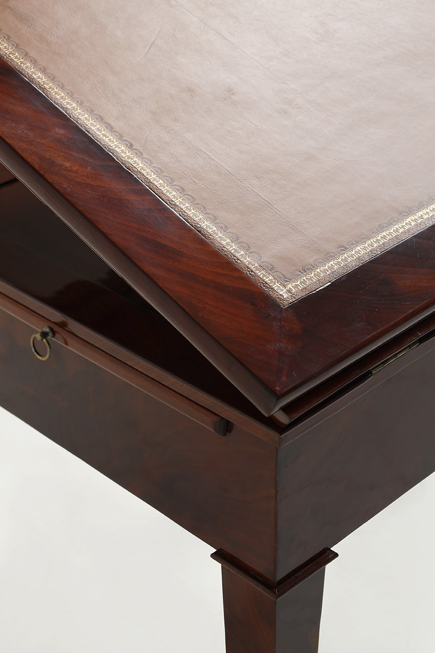 Wooden desk with a raised flap on a white background