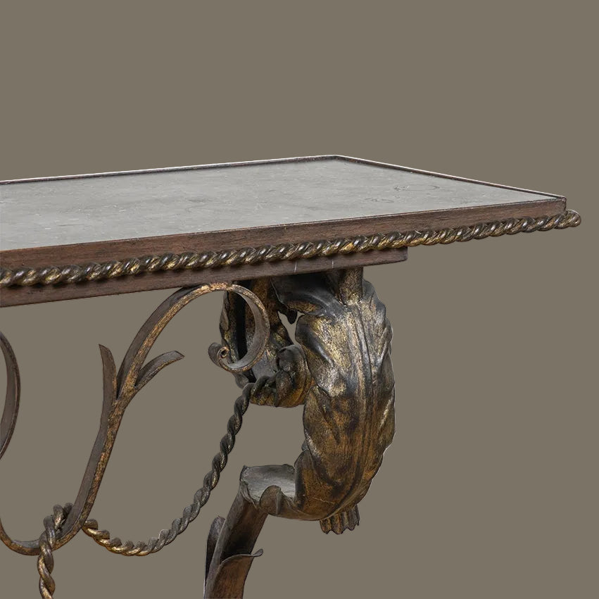 Decorative metal table with intricate design on a plain background