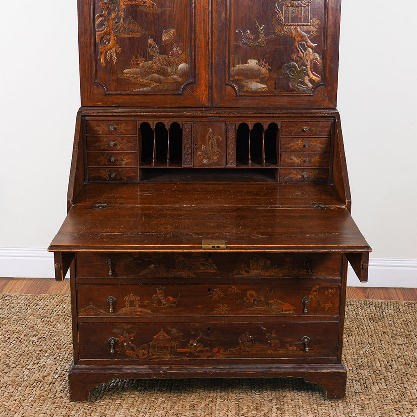 Vintage wooden desk with intricate carvings on a plain background