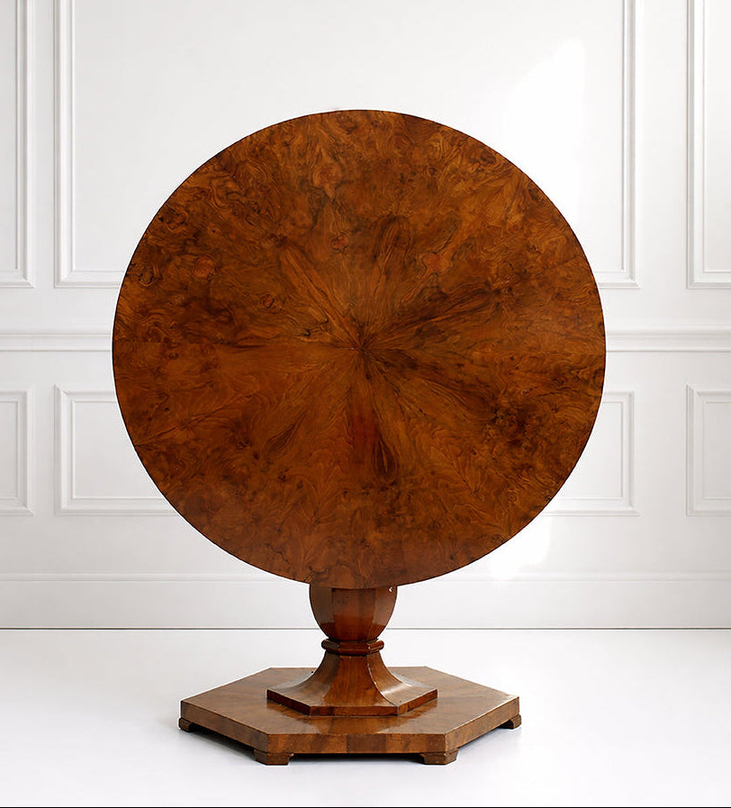 Wooden round table with a hexagonal base on a white background