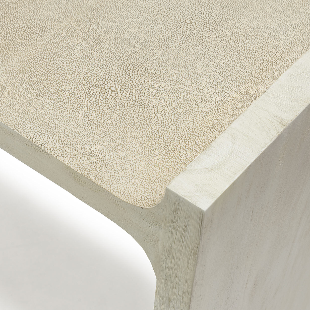 Close-up of a textured beige surface with a wooden edge.