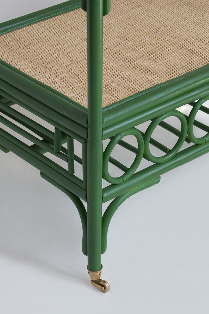 Green rattan frame with woven seat on a white background
