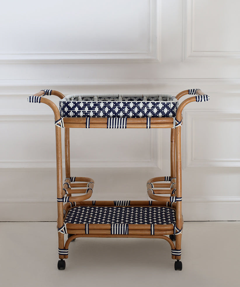 Rattan bar cart with black and white checkered top and bottom on a white background