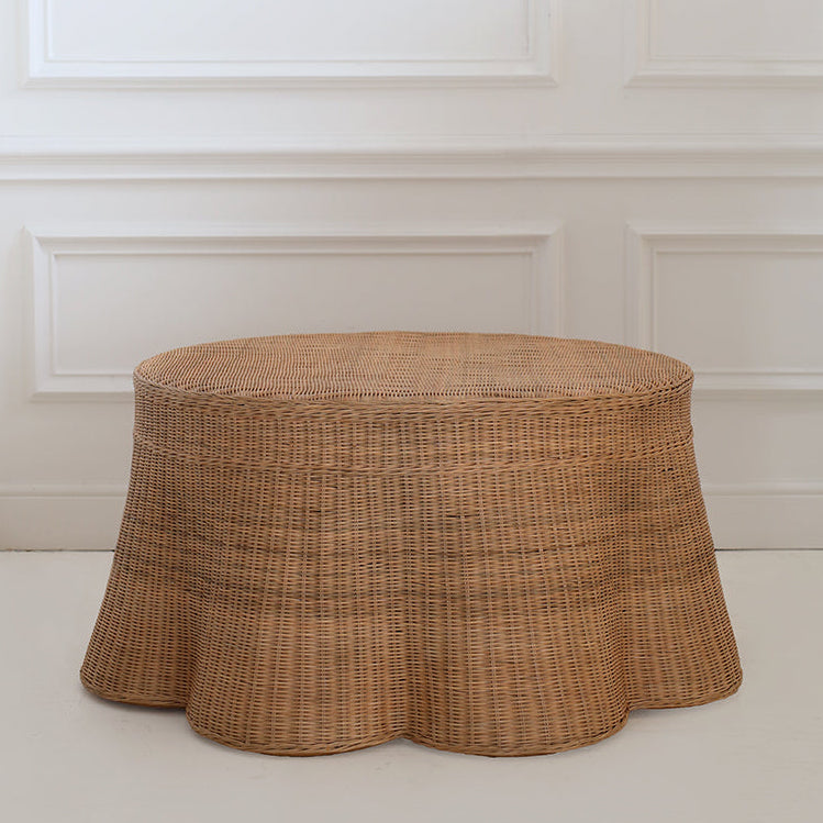 Handcrafted rattan ottoman against a white panelled wall