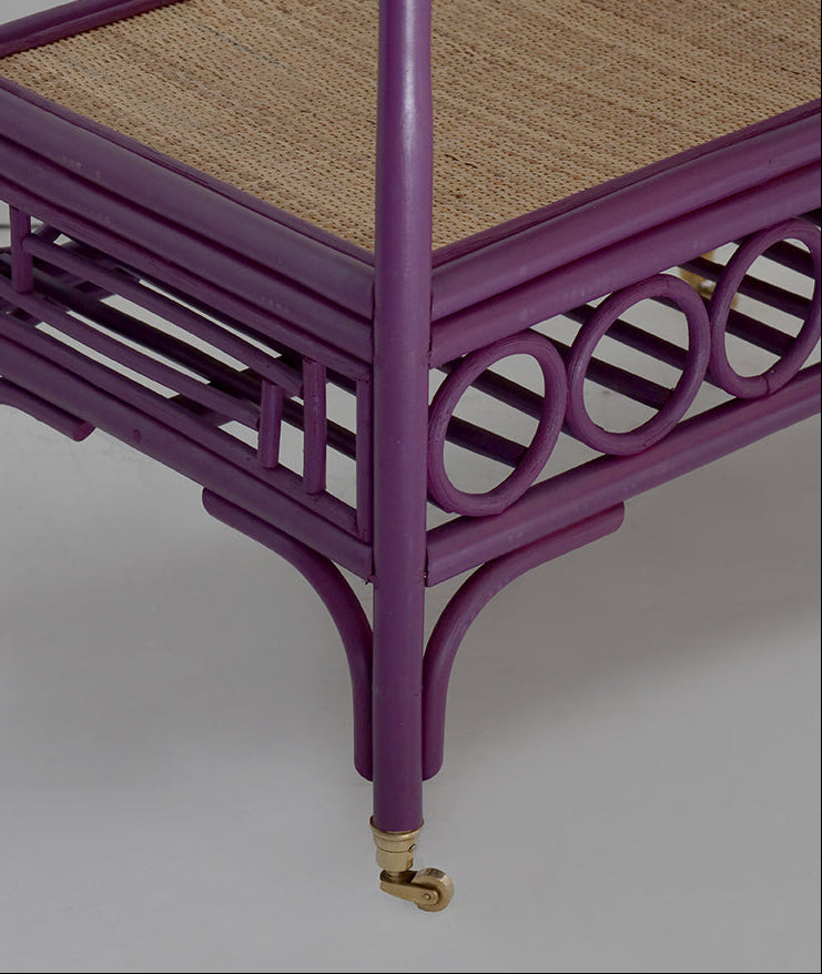 Purple rattan cart with woven top on a gray background