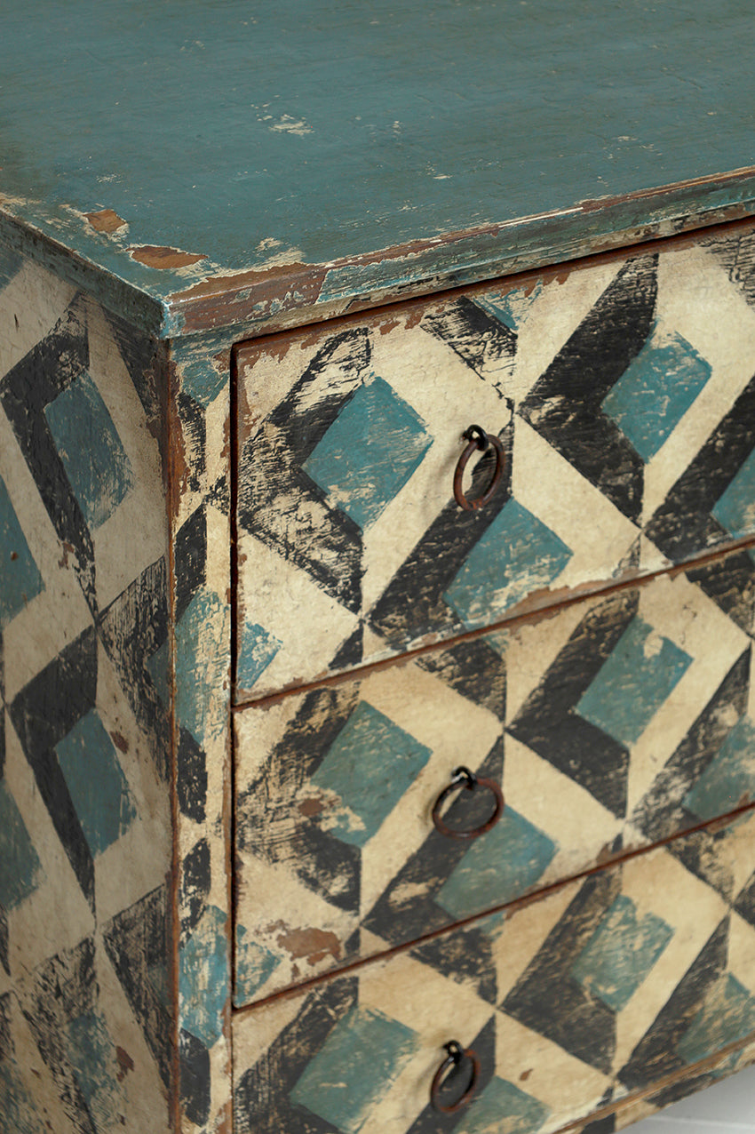 Vintage wooden cabinet with geometric pattern and peeling paint
