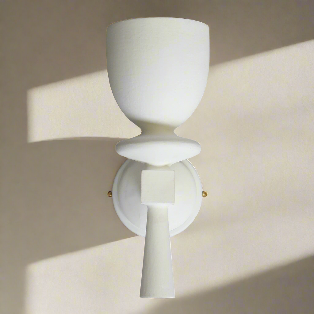Modern wall sconce with a white ceramic design on a neutral background