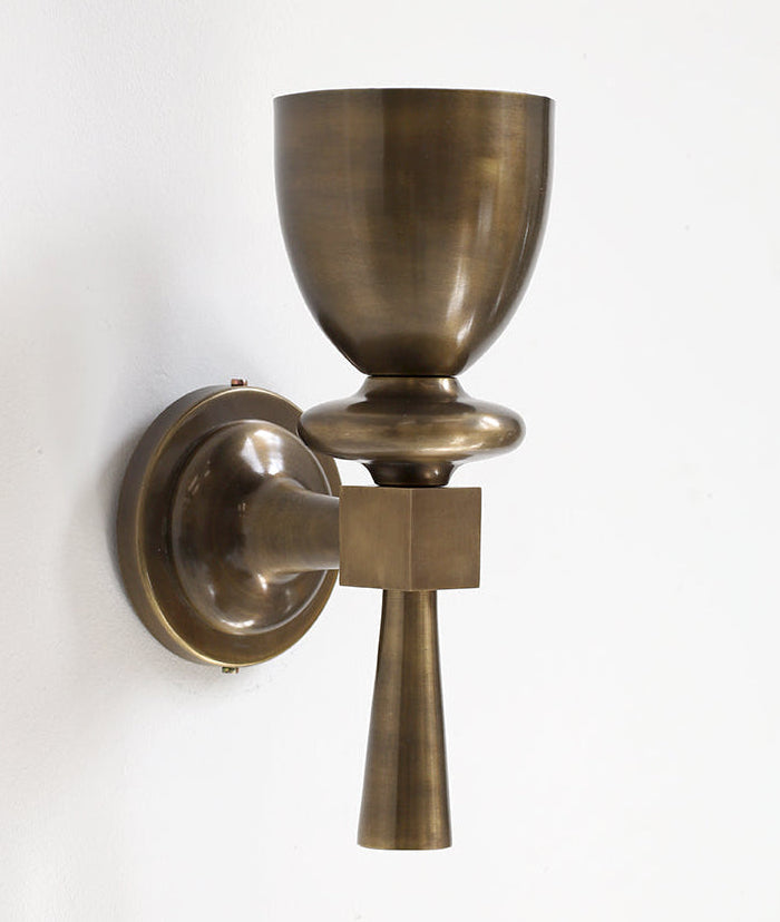 Brass wall sconce on a white background
