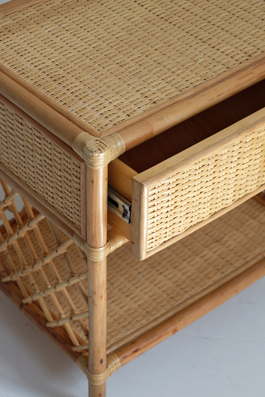 Wicker side table with a drawer on a white background