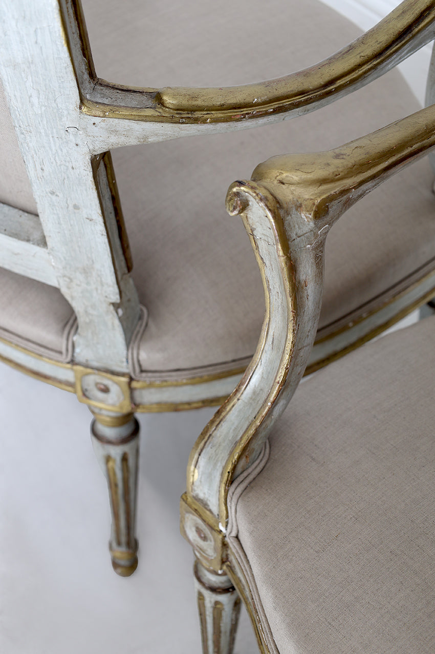 Close-up of a decorative chair with gold accents on a white background