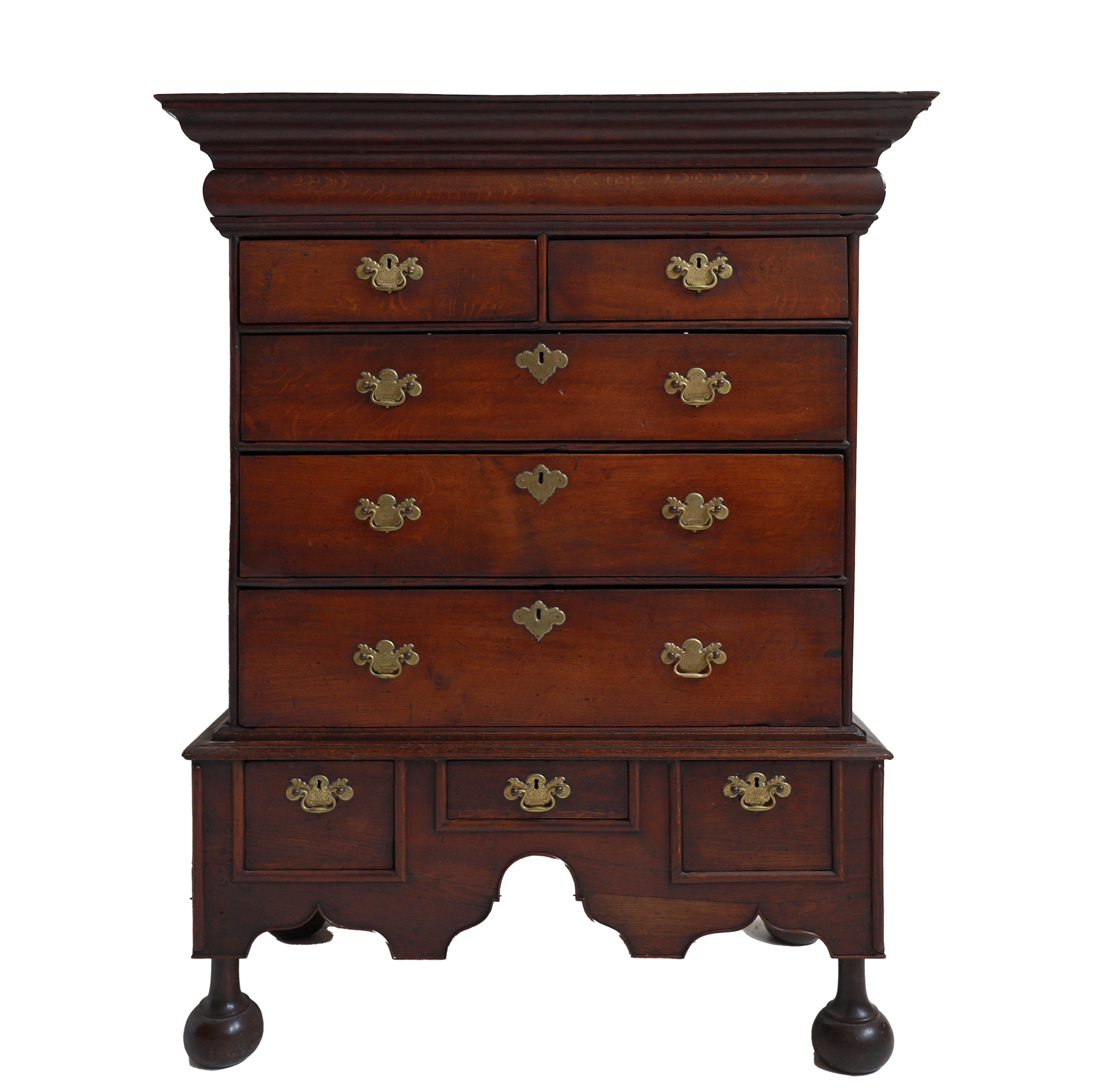 Wooden dresser with multiple drawers and brass handles on a white background