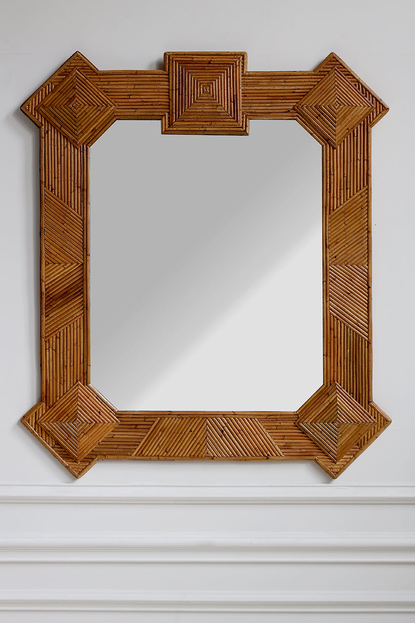Wooden framed mirror on a white wall