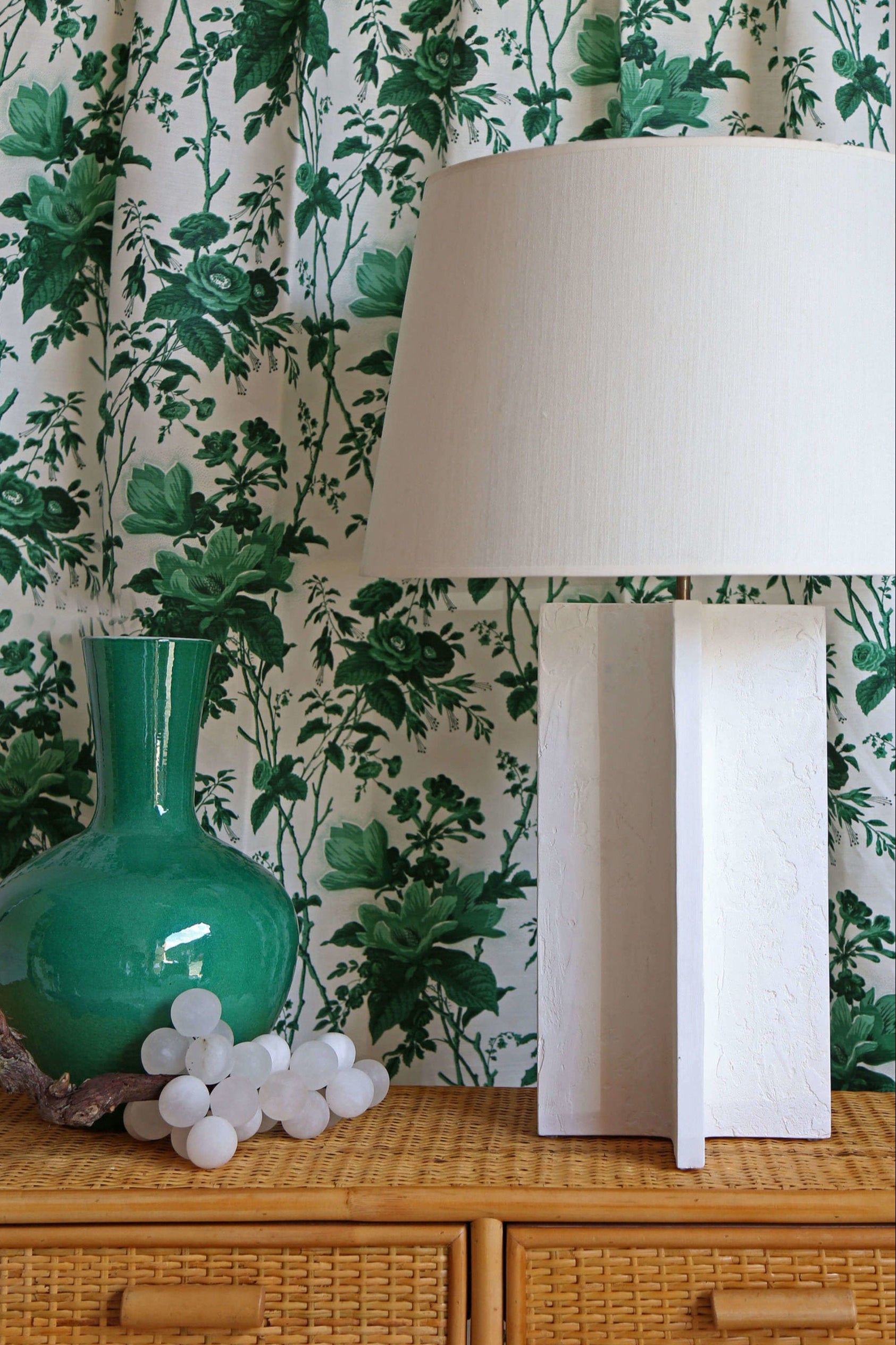 Vignette.De La Tour Paolo’s Green.Michel Table Lamp.Nino Rattan Console.Alabaster Grapes
