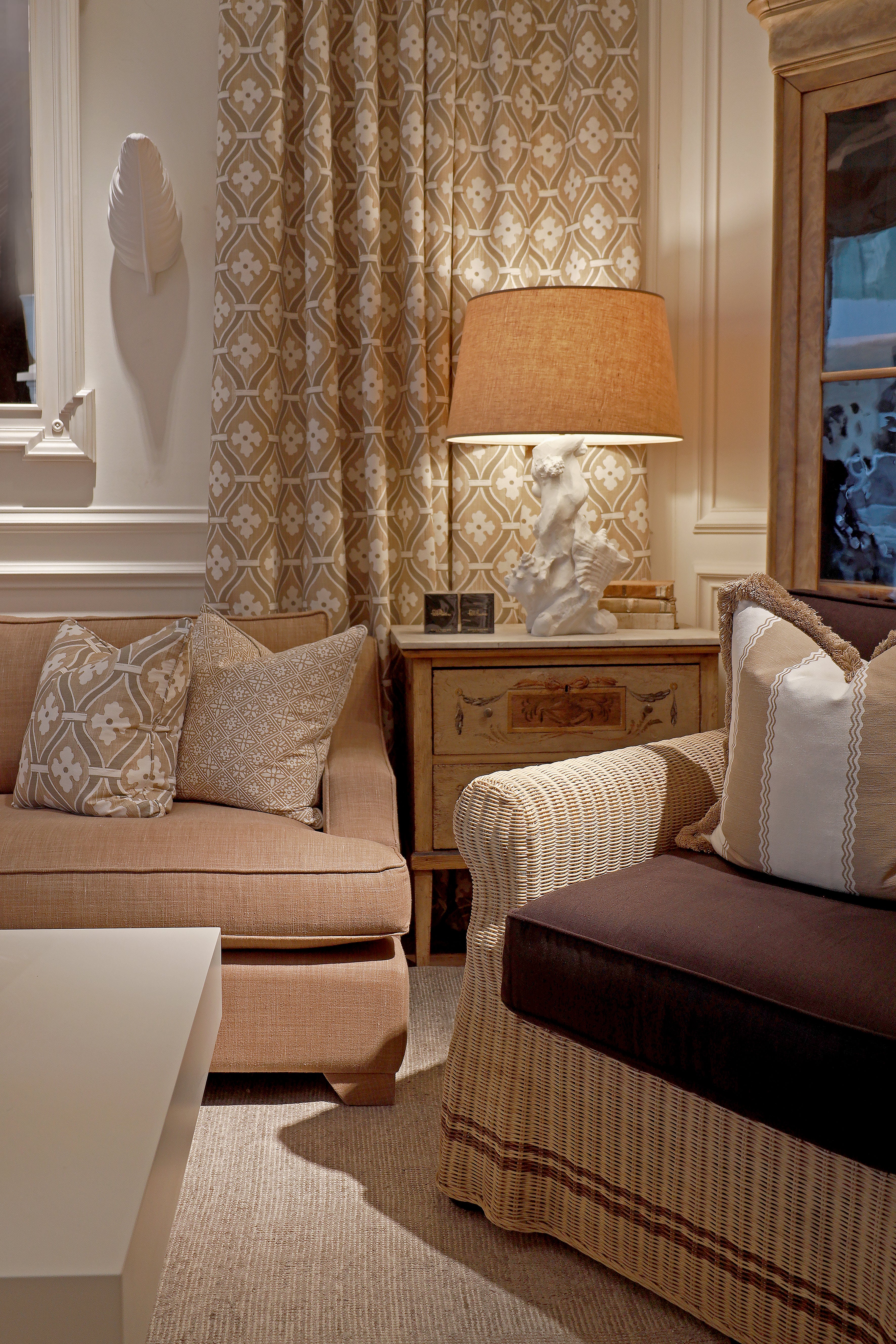 Living room with beige sofa, patterned curtains, and decorative lamp.