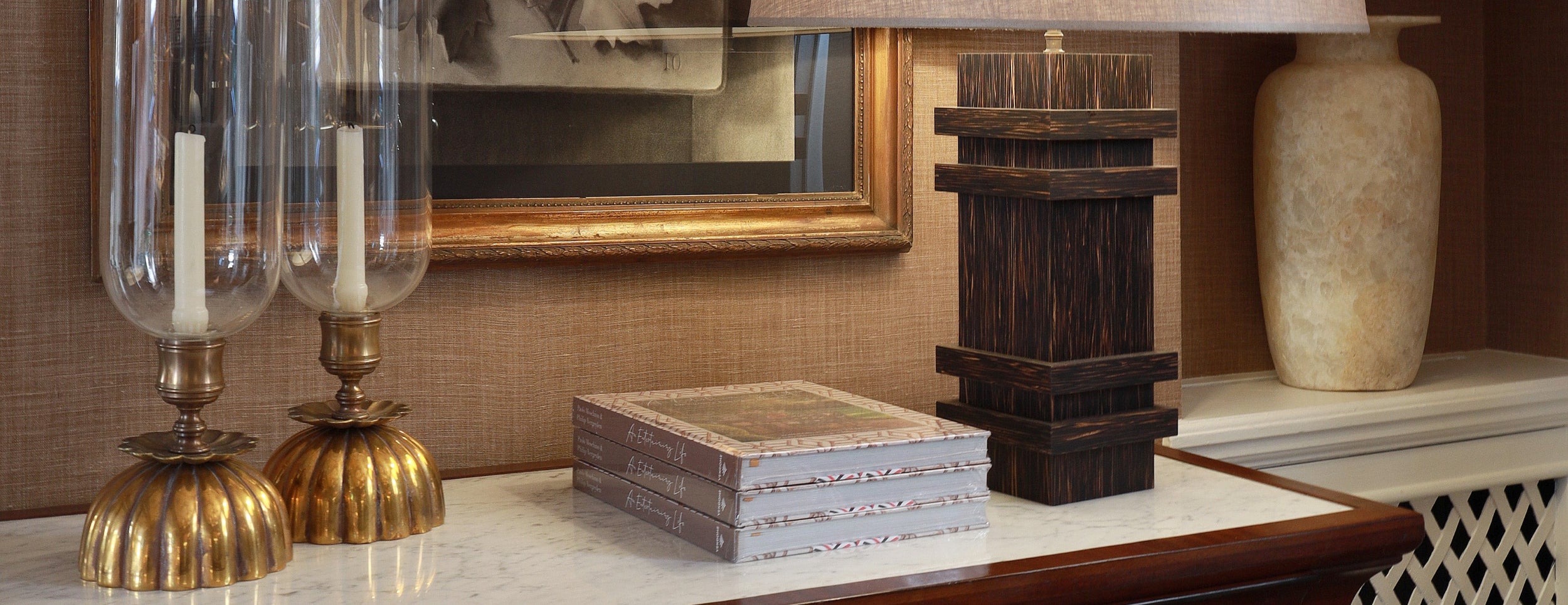 Decorative items on a shelf including glass lamps, books, and a vase.