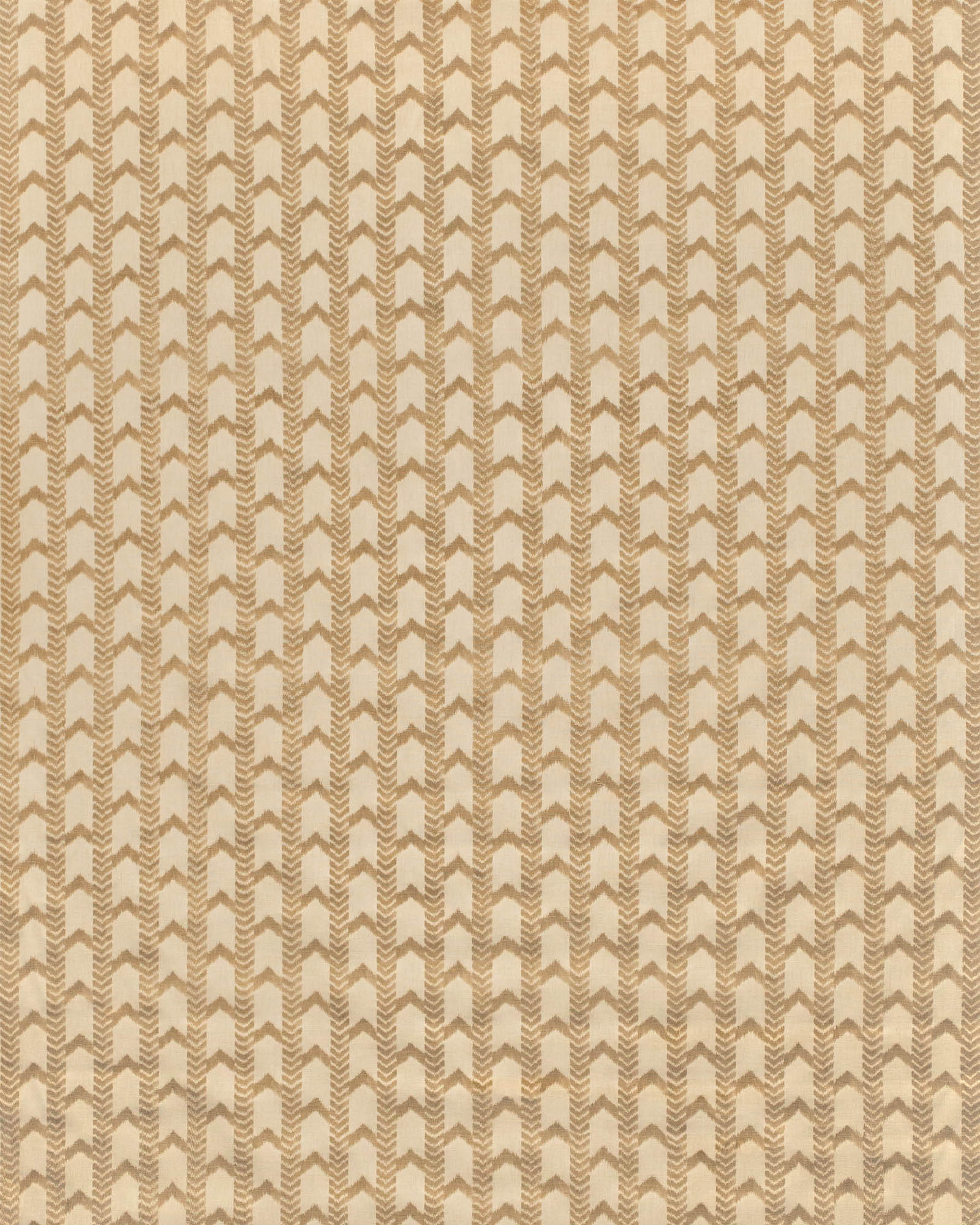 Textured patterned fabric swatch in beige and brown tones