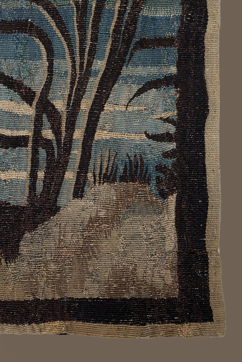 Textile with a nature-themed design featuring trees and grass on a blue background