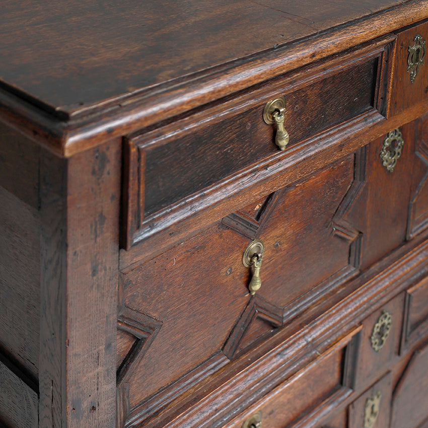 Close-up of an old wooden dresser with brass handles