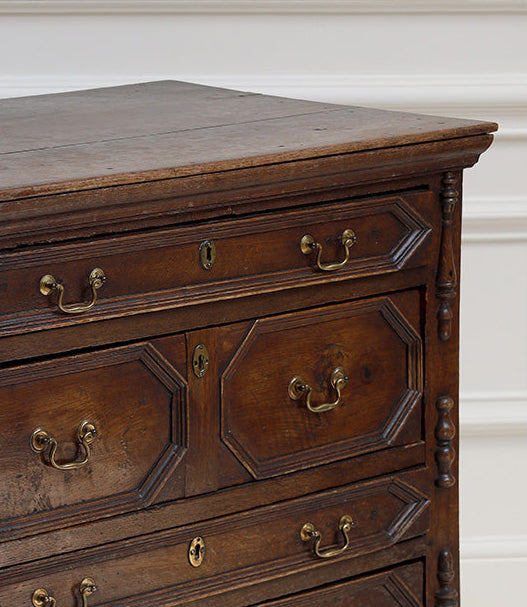 Wooden dresser with brass handles on a white background