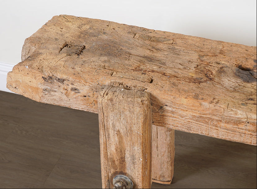 Wooden bench with a rustic design on a plain background