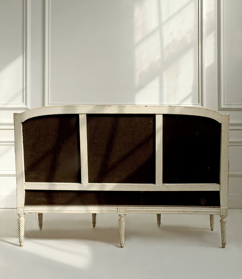 Decorative cabinet with black glass panels against a white wall