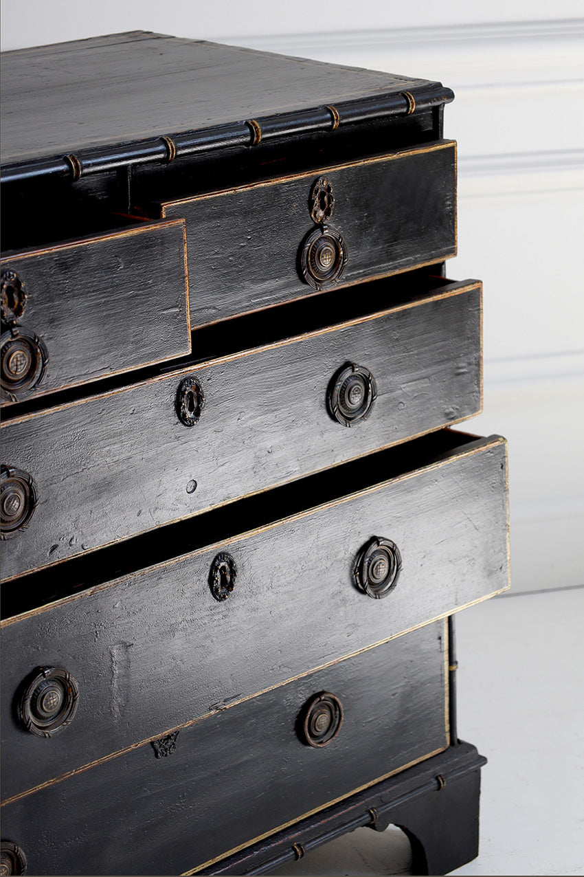 Black wooden dresser with brass handles on a white background