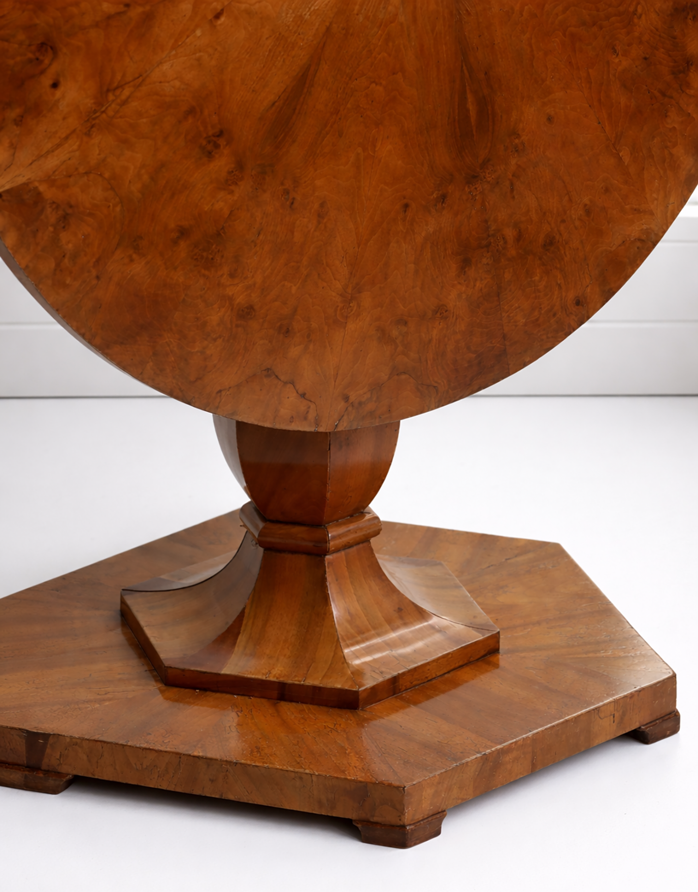 Wooden pedestal table with a hexagonal base on a white background