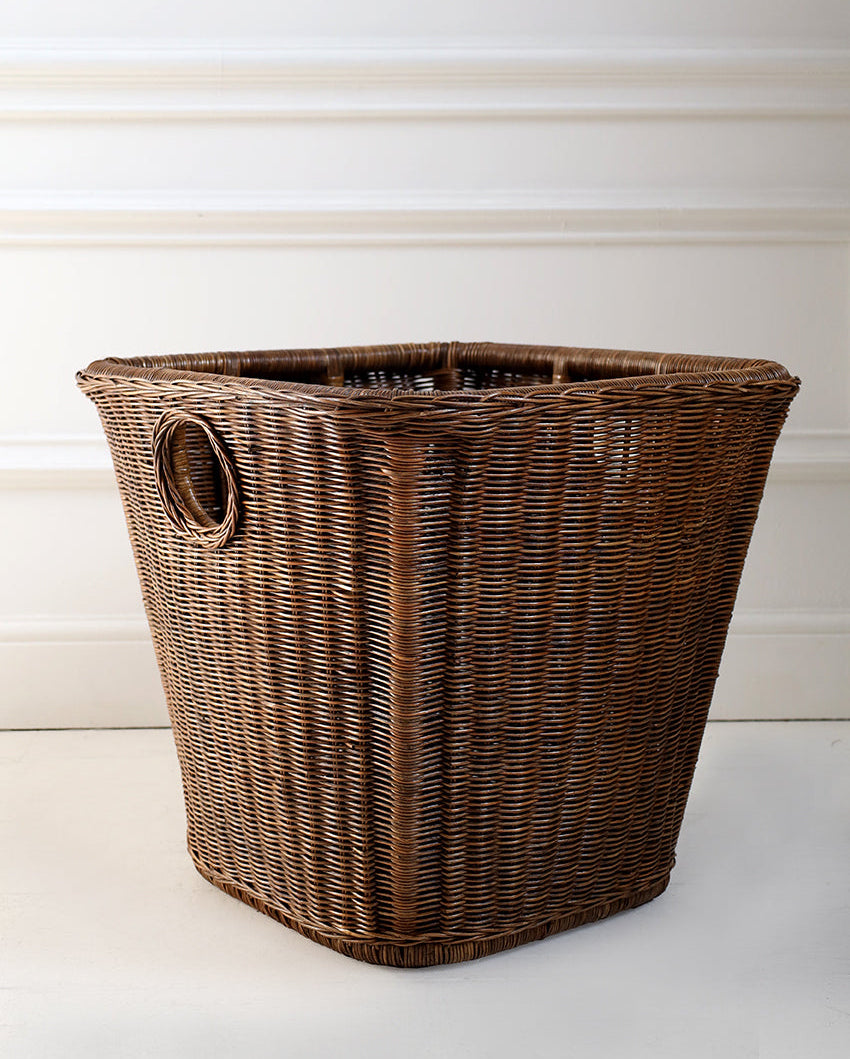 Wicker laundry basket on a white background