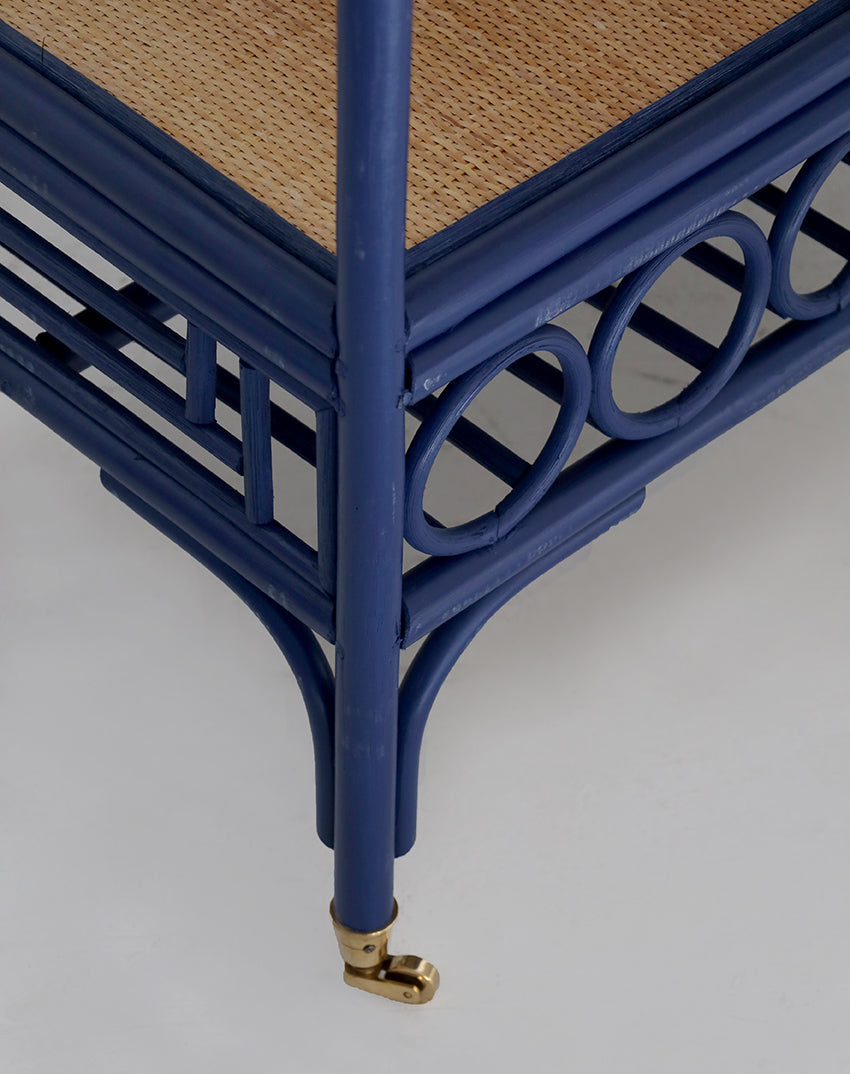 Blue rattan cart with woven seat on a light gray background