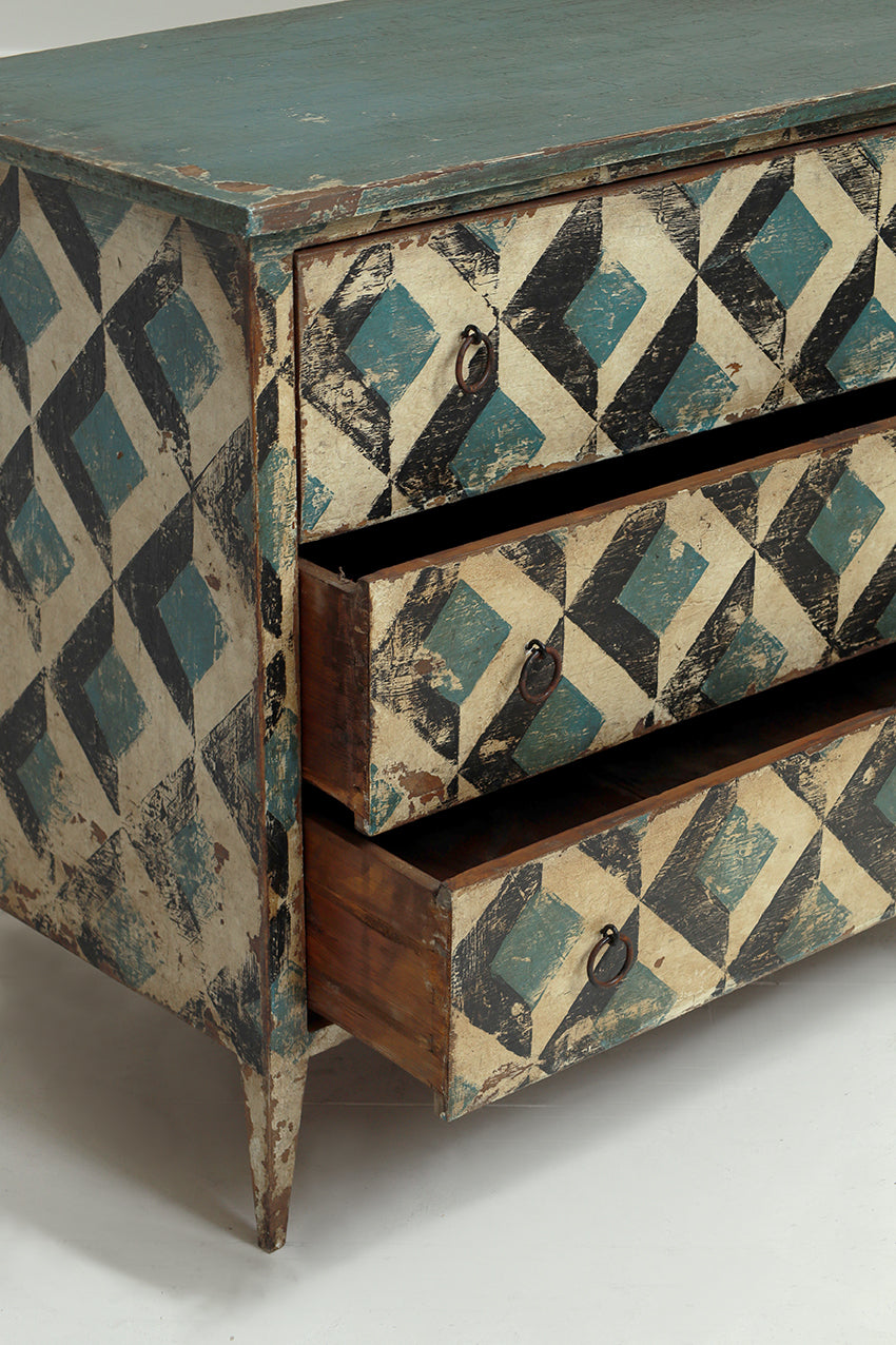 Wooden dresser with geometric pattern on a white background