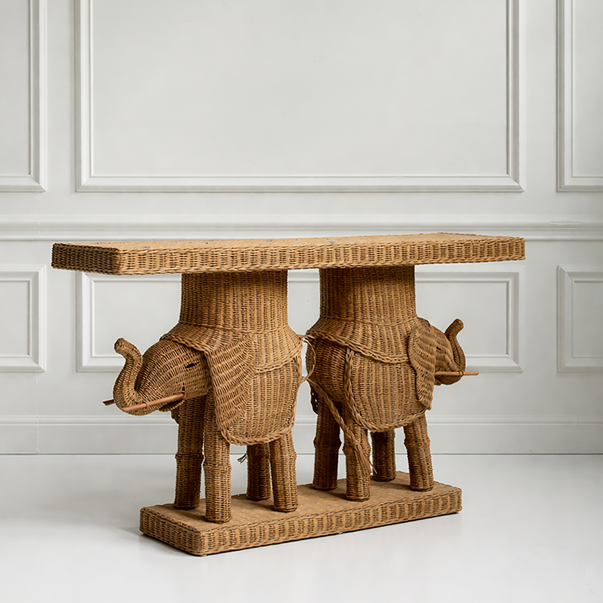 Wicker elephant table against a white paneled wall