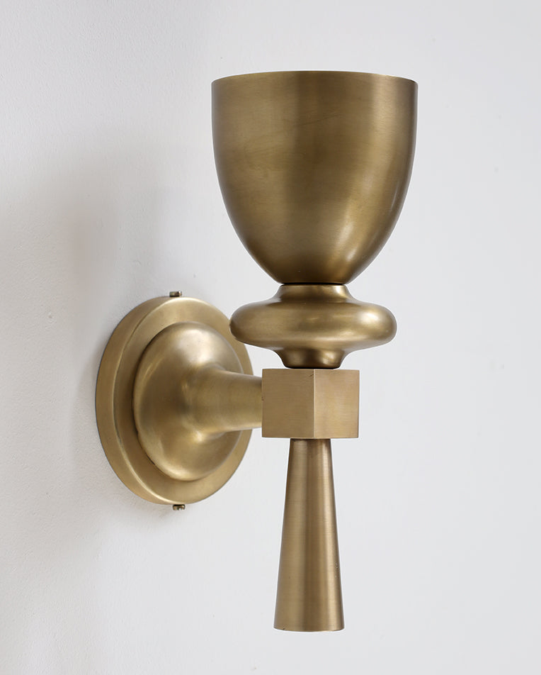 Brass wall sconce on a white background