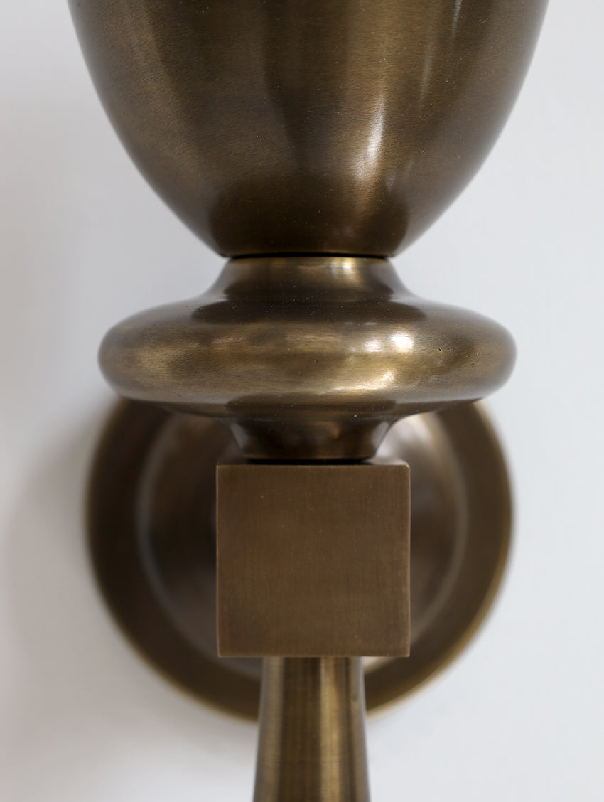 Close-up of a bronze door handle on a white background