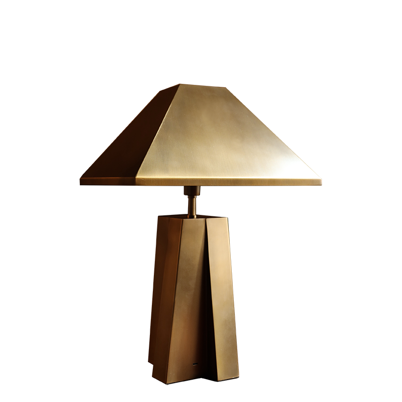 A modern table lamp with a geometric, faceted bronze base and a matching triangular shade, shown against a plain white background.