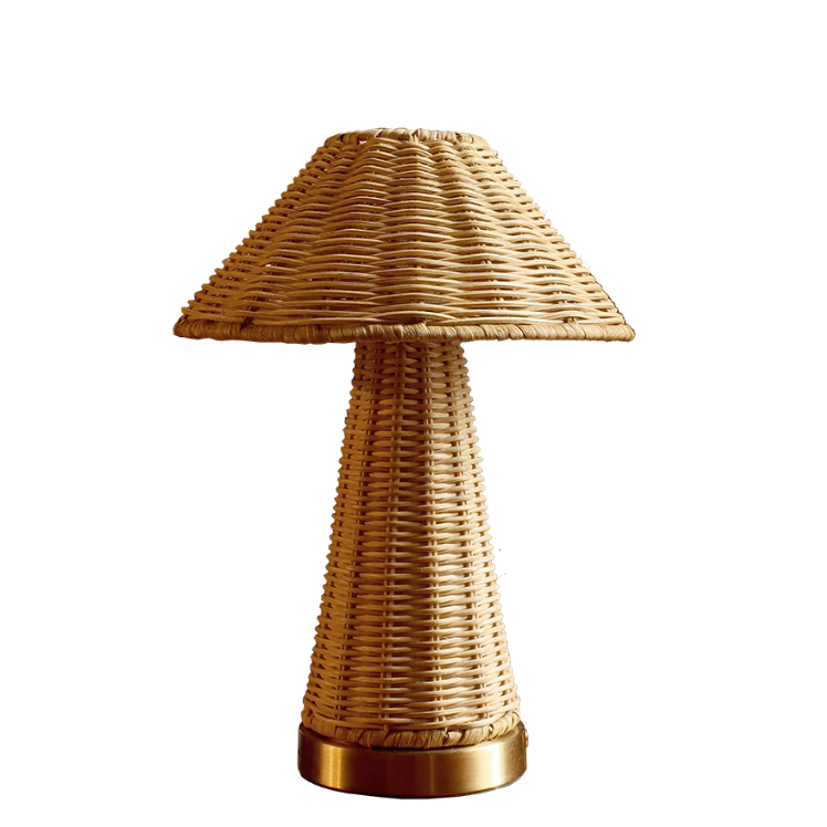 A mushroom-shaped table lamp made of woven natural rattan with a metallic gold base, isolated on a white background.