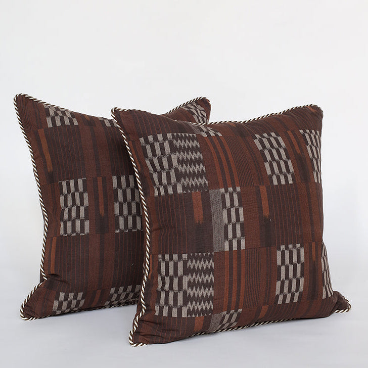 Two patterned pillows on a white background