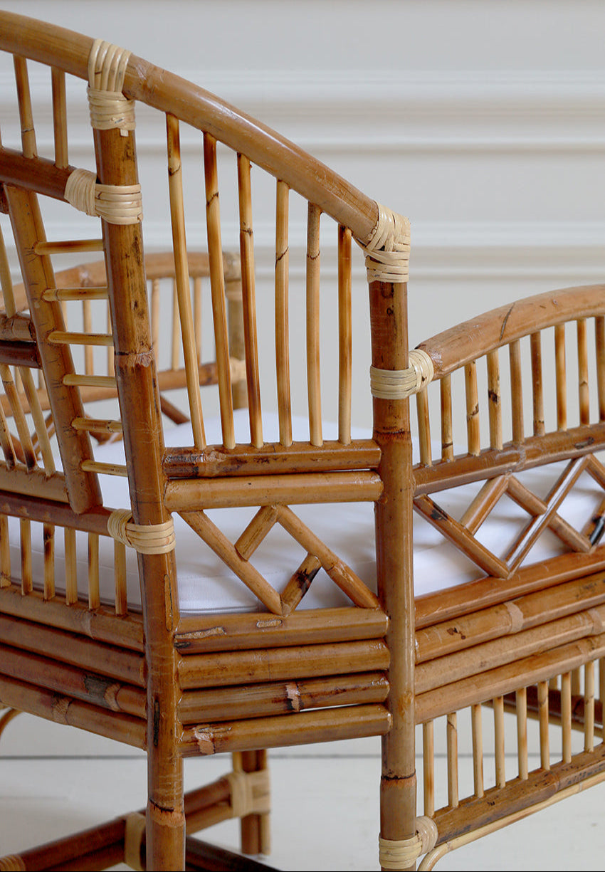 Close-up of a bamboo chair with woven design on a white background