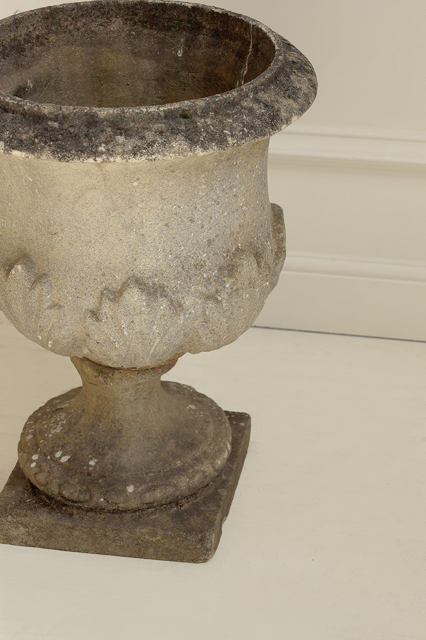 Decorative stone urn on a plain background