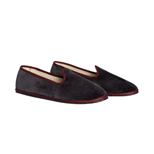 Pair of dark gray slippers with red trim on a white background