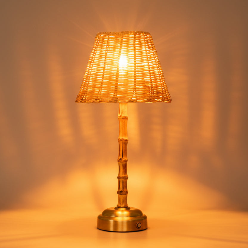 Table lamp with woven shade and bamboo-style base on a gray background
