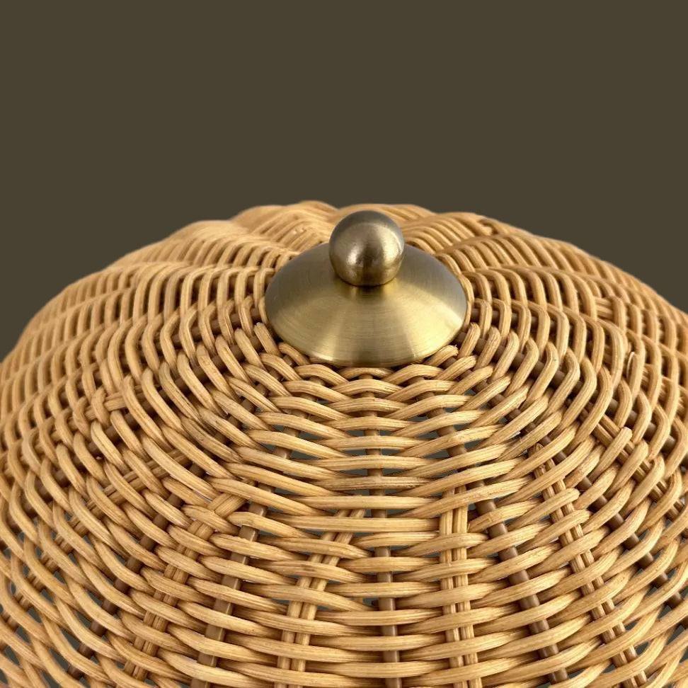Woven basket with a gold lid on a gray background
