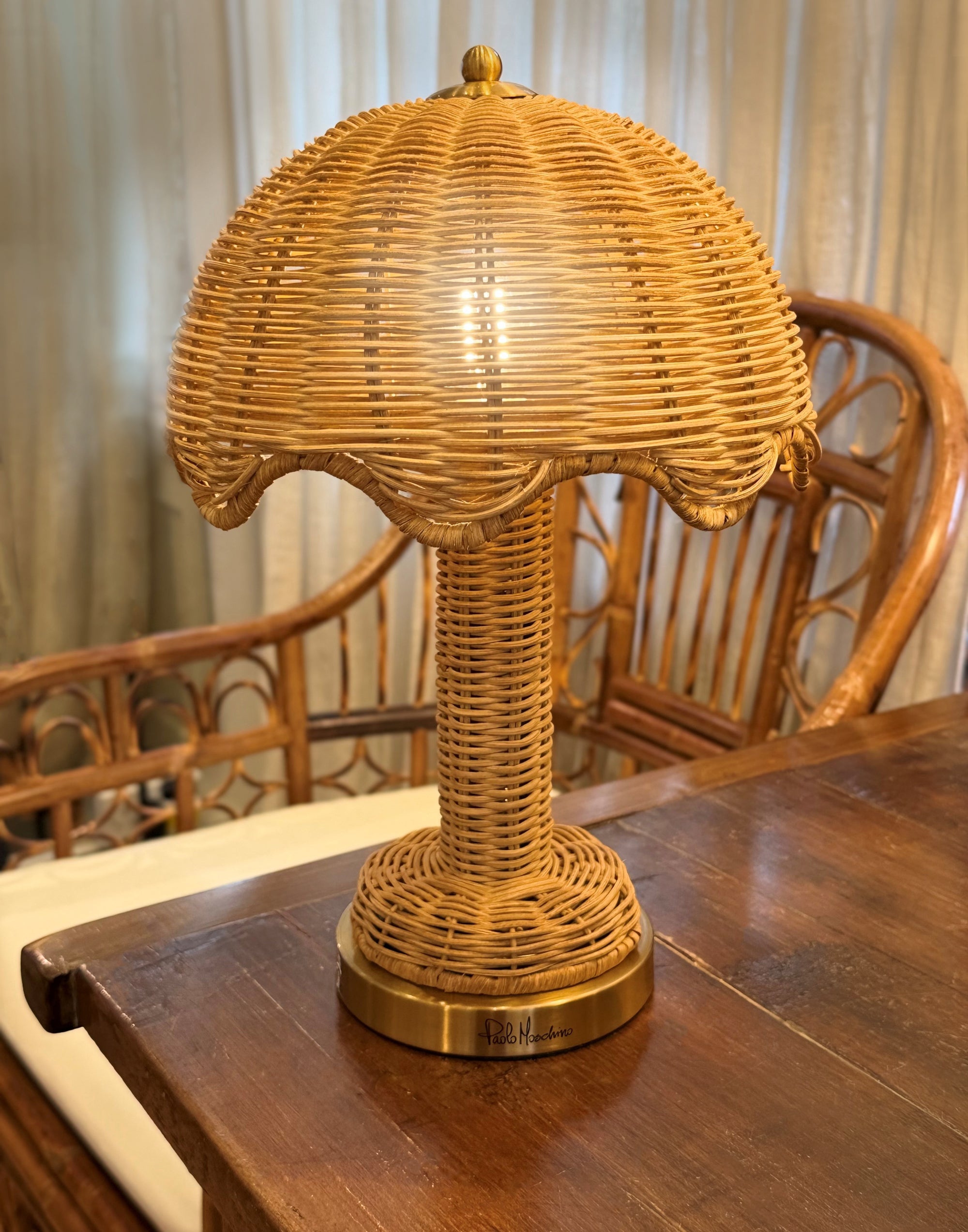 Wicker table lamp on a wooden table with a blurred background