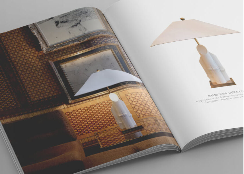 Open book with interior design images on a gray surface